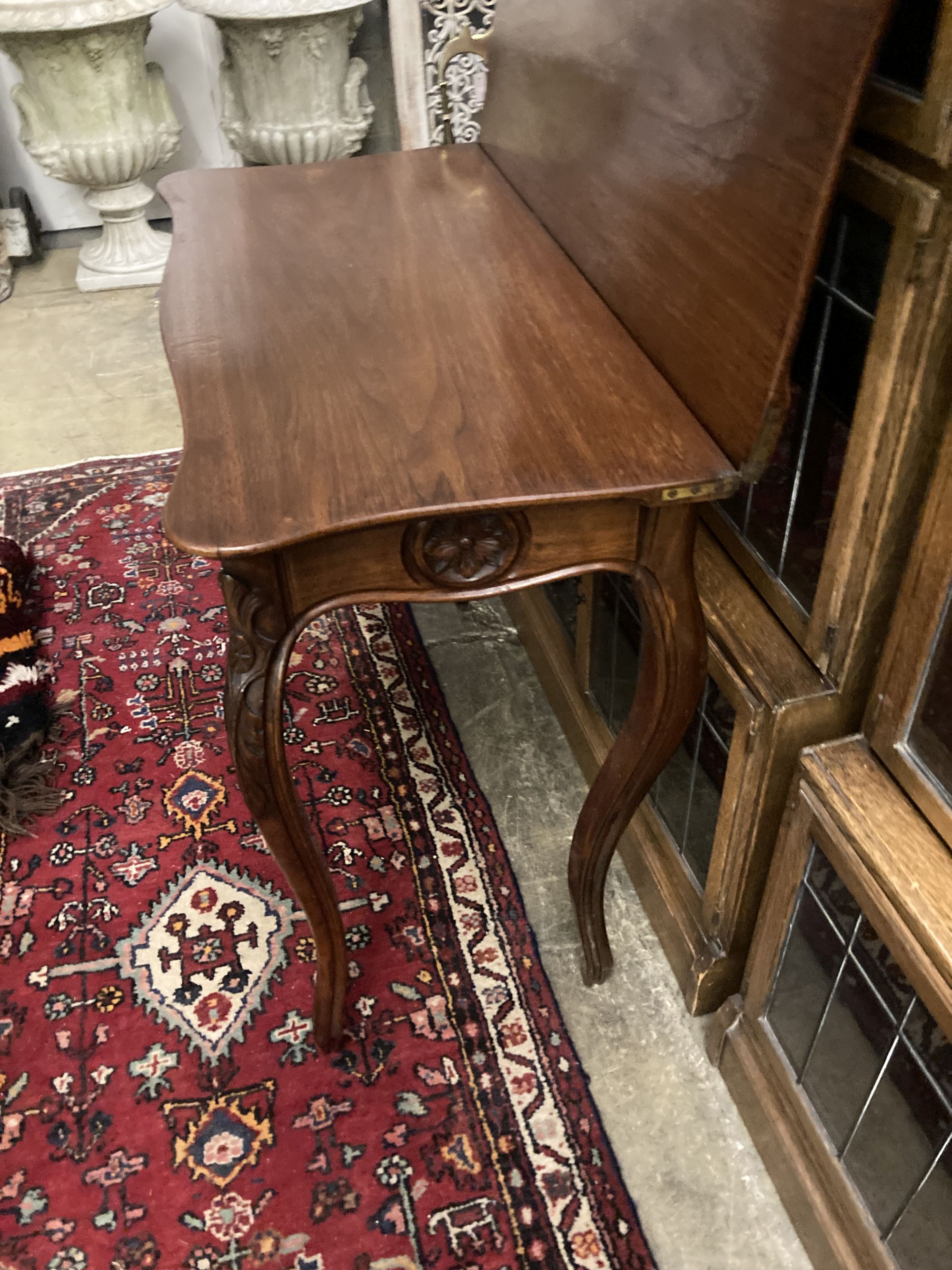 A 19th century French walnut serpentine folding tea table, width 85cm, depth 42cm, height 76cm